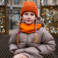 Girl wearing Taupe Puffer Jacket with orange beanie and snood outdoors in winter with Christmas lights